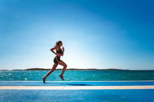 Woman running showing strong leg muscle Camden
